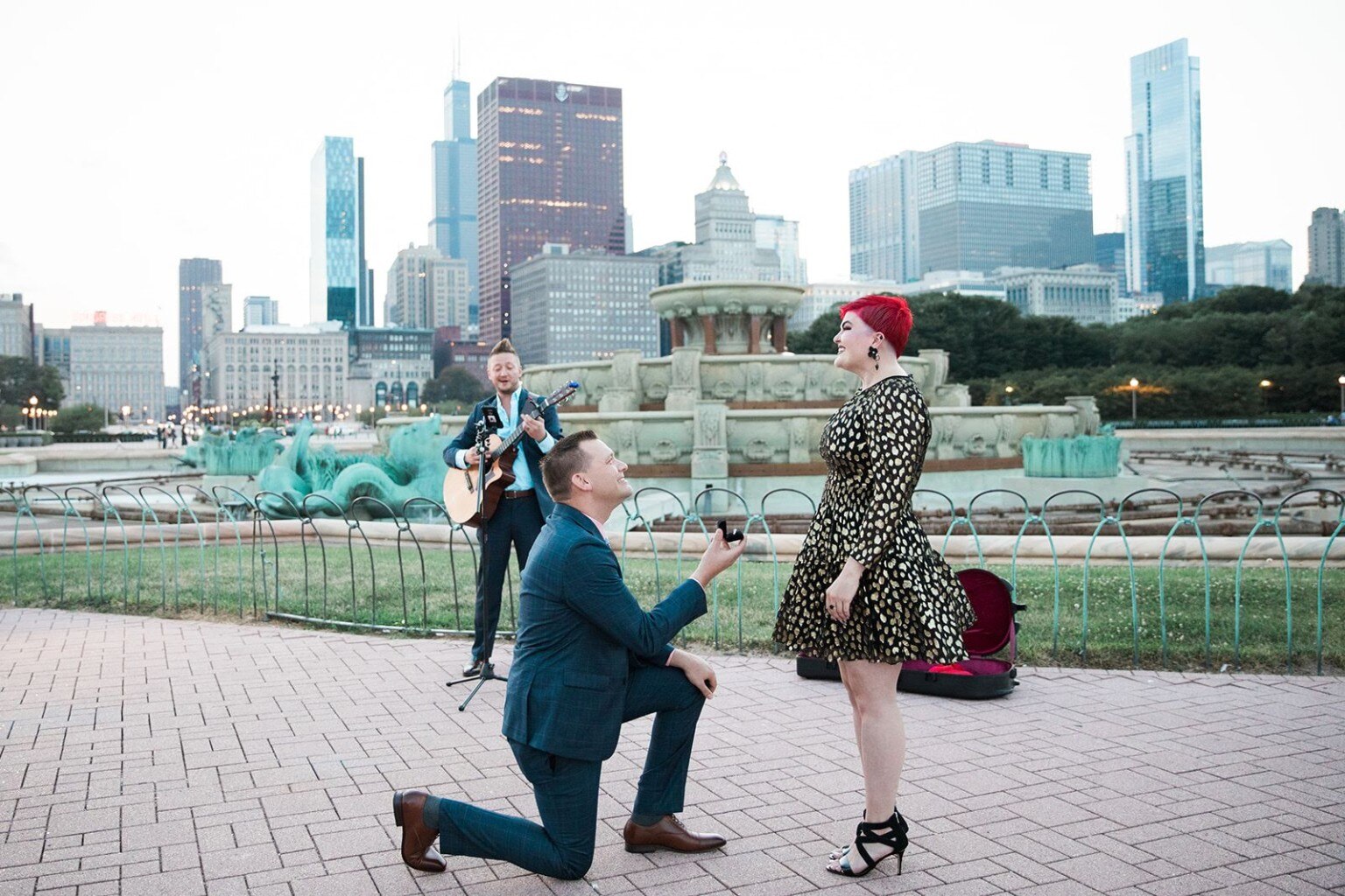 A proposal at Buckingham Fountain with JD Kostyk performing live music nearby